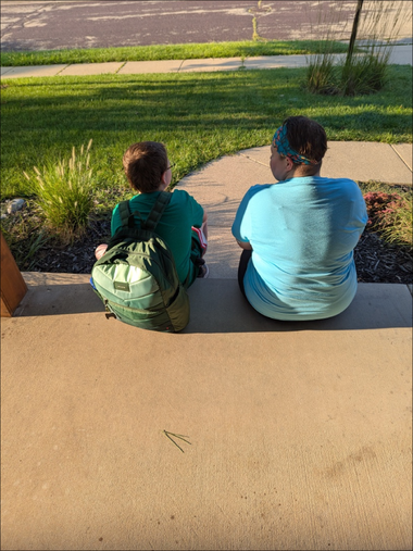 first day of school 2025 with wyatt and rhiannon Rhiannon and Wyatt sitting at the front step waiting for the bus