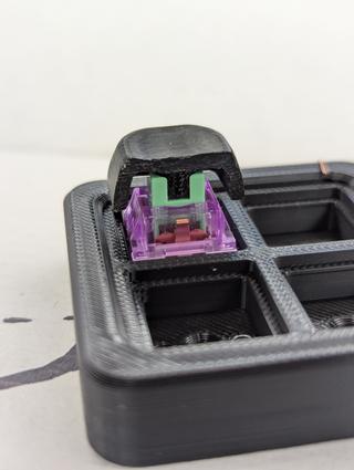 cutaway key cap up A cutaway keycap sitting on a durock lupine switch