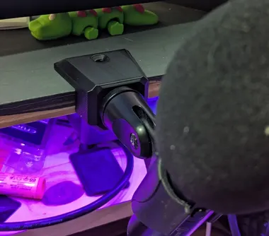 3d printed microphone mount A 3d printed microphone mount that is slim minimal and holds a mic at just the right spot on my desk.