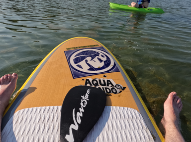 toes in the water of Lake Michigan Sitting on a paddle board on Lake Michigan, enjoying the cool water on a hot day.