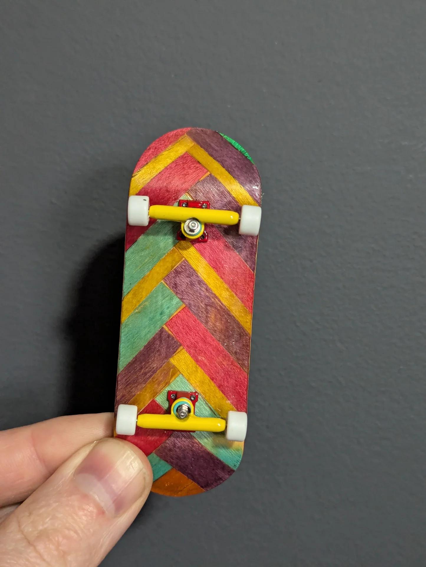 Heringbone Fingerboard I just finished up my latest 6 ply wood fingerboard. I used scraps of purple, blue, red, and gold from the first 5 boards I built to…